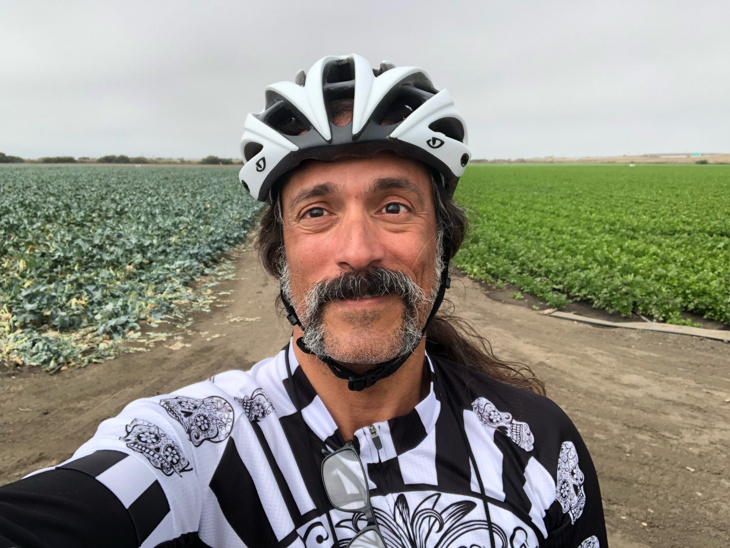 Stew on his ride with fields behind him